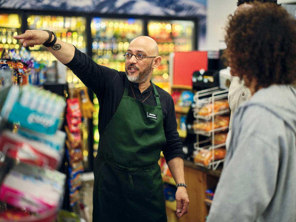 GettyImages-1996154002 (1) Convenient store owner directing customers where to buy 5-hour ENERGY®